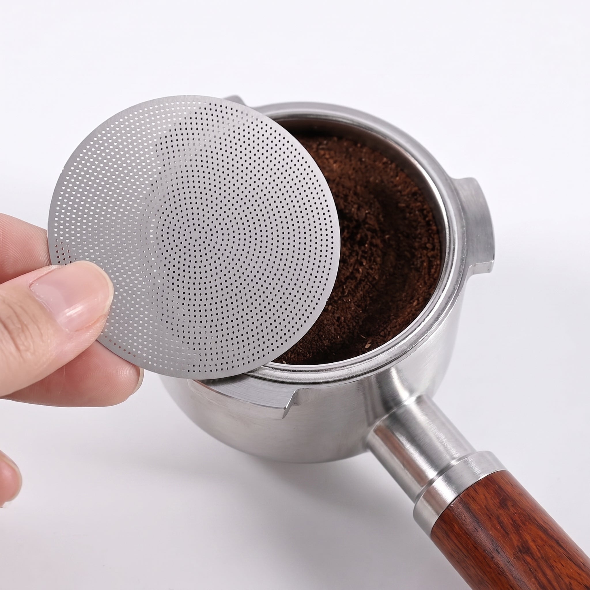 Placing the 53.5mm puck screen on the tamped coffee bed